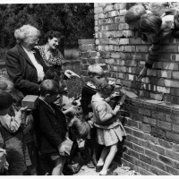 Pupils of Chenies School laying bricks personalised to themselves in the wall of The Pightle in 1951