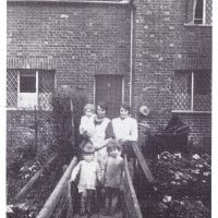 Mill cottages, later Mill Farm, 1930s. Mrs Rose Maling holds her son Kenneth; beside her, sister Hilda Bastin; David Maling stands on the bridge with cousin John Bastin. Photo credit: Rose Maling. Used with kind permission from Carolyn Birch.